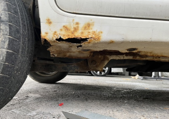 Corrosion at the bottom panels of a used car